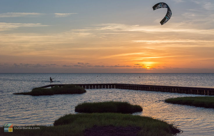 Kiteboarding at sunset in Waves